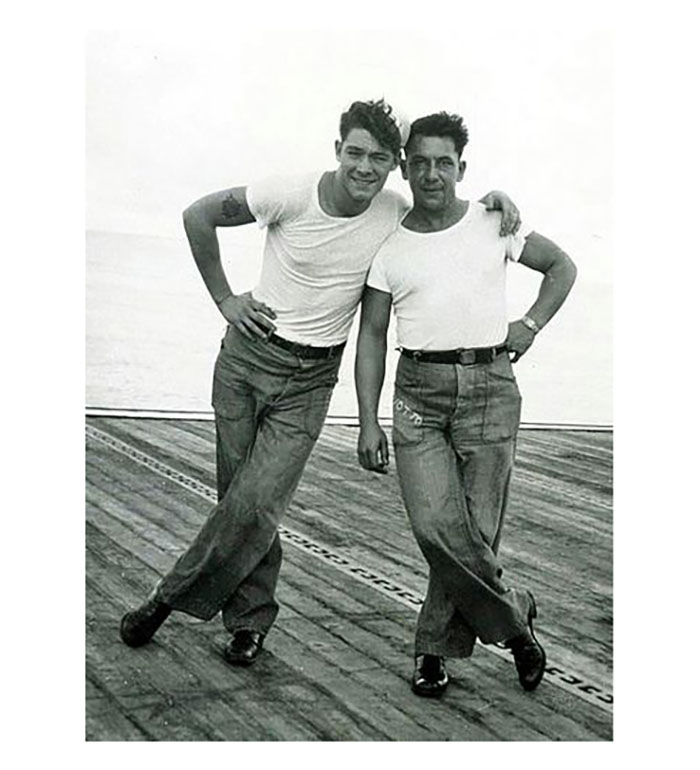 Sailors posing on the deck of aircraft carrier